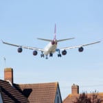 Aeroplane flying over houses